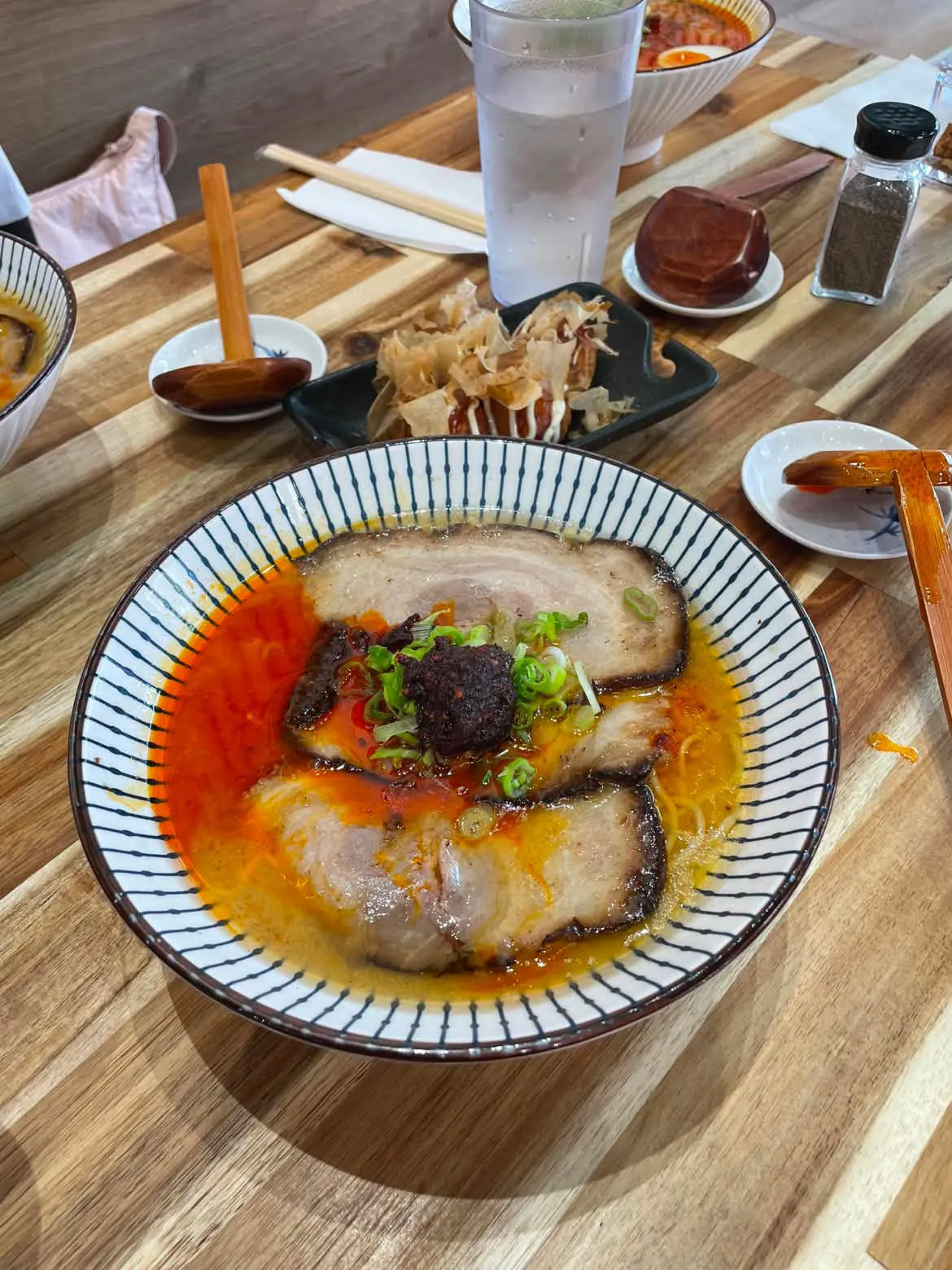 Ramen bowl with chashu, chili oil, and green onions